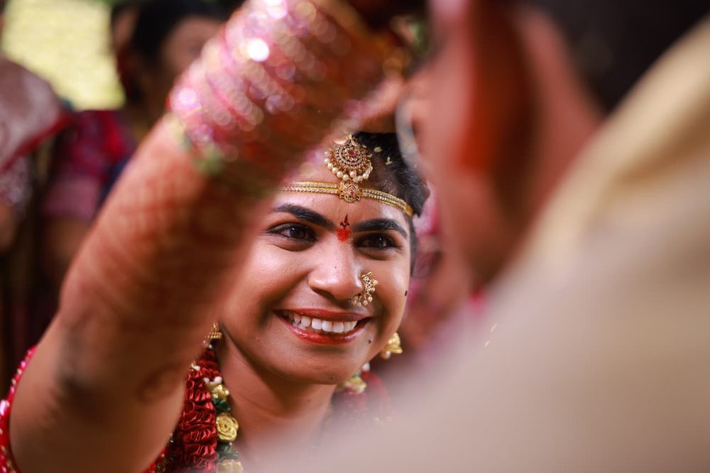 Bride smiling during a blessing ritual