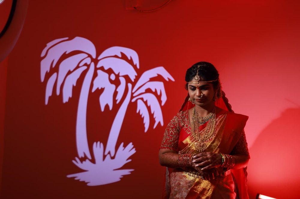 Bride in traditional red saree and gold jewellery