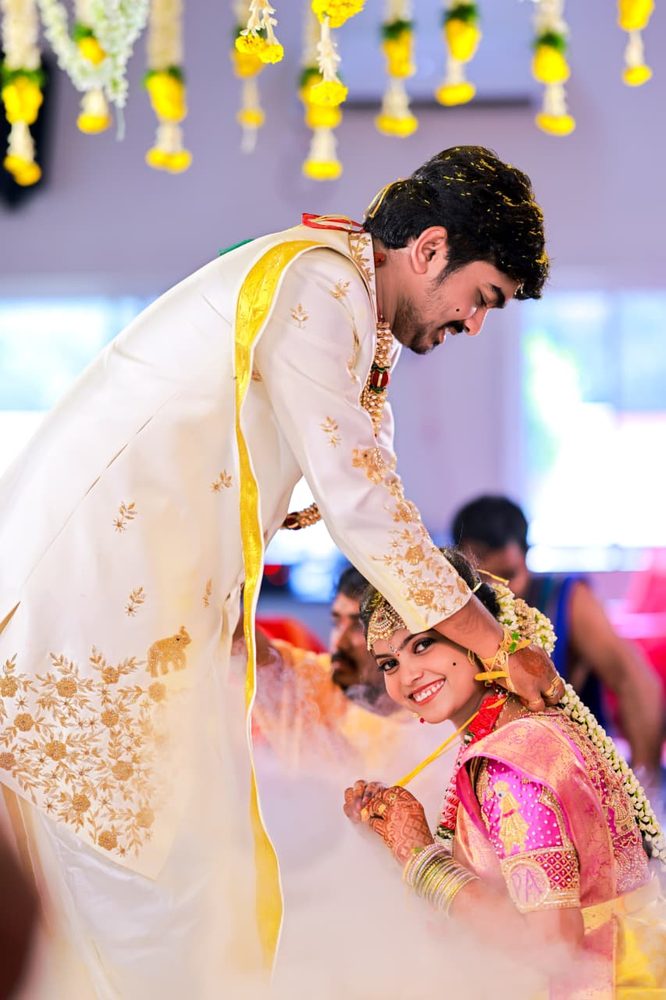 Groom tying the mangalsutra during the wedding ceremony