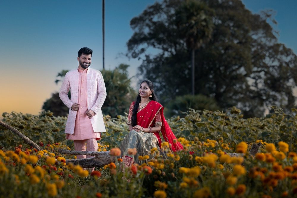 Couple portrait in a marigold flower field at dusk