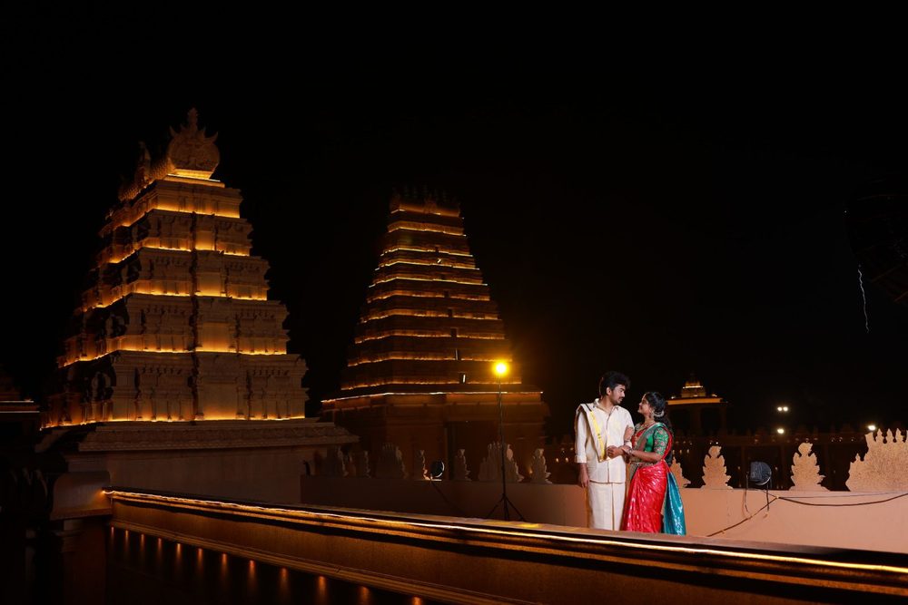 Couple pre-wedding shoot at an illuminated temple at night